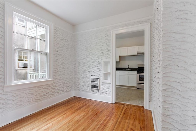 4237 Fontainebleau Dr, New Orleans, LA 70125 - spare room with light wood-style flooring and heating unit
