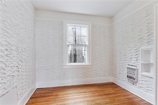 4237 Fontainebleau Dr, New Orleans, LA 70125 - unfurnished room featuring heating unit and wood finished floors
