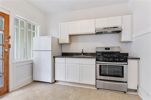 4237 Fontainebleau Dr, New Orleans, LA 70125 - kitchen with under cabinet range hood, stainless steel range with gas stovetop, freestanding refrigerator, and dark countertops