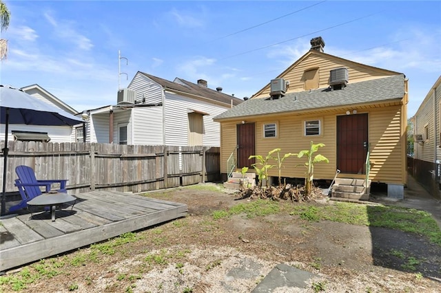 274446 Dumaine St, New Orleans, LA 70119 - back of property with central AC, fence, roof with shingles, and entry steps