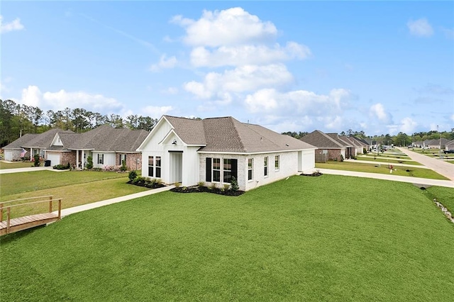rear view of house featuring driveway, an attached garage, and a yard