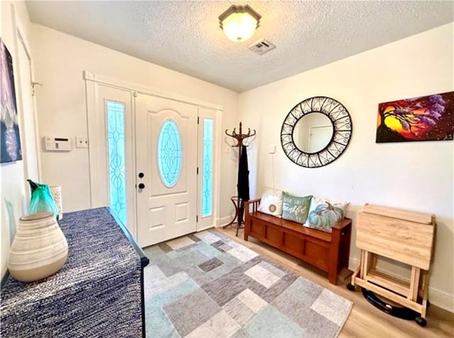 2516 E Pearl Dr, Marrero, LA 70072 - foyer featuring a textured ceiling and wood finished floors