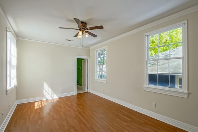3611 Elaine Pl, New Orleans, LA 70119 - spare room with ornamental molding, a ceiling fan, visible vents, wood finished floors, and baseboards