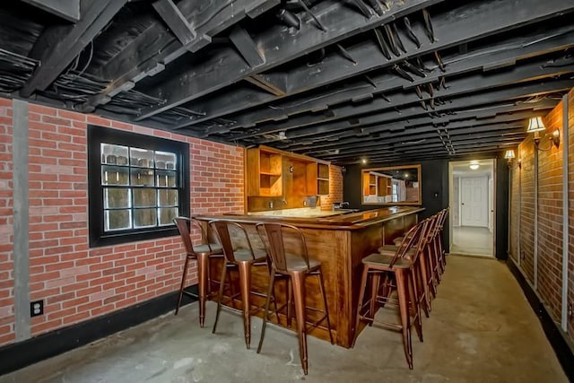 3611 Elaine Pl, New Orleans, LA 70119 - bar with concrete floors, brick wall, and indoor wet bar