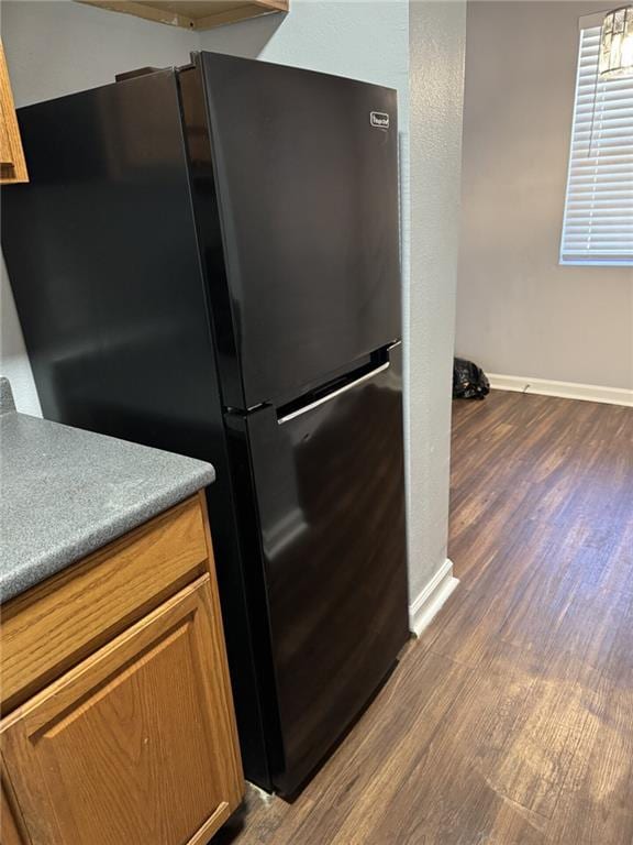4518 Y A Tittle Ave Unit 6, Baton Rouge, LA 70820 - kitchen featuring freestanding refrigerator, dark wood-type flooring, baseboards, and brown cabinets