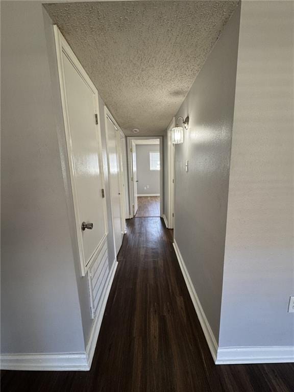 4518 Y A Tittle Ave Unit 6, Baton Rouge, LA 70820 - corridor featuring a textured ceiling, dark wood-style floors, and baseboards