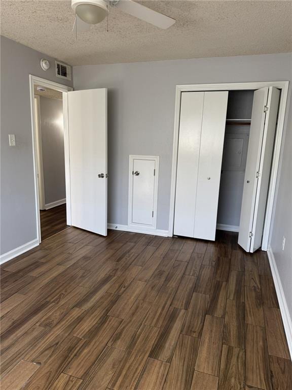 4518 Y A Tittle Ave Unit 6, Baton Rouge, LA 70820 - unfurnished bedroom featuring a closet, a textured ceiling, visible vents, baseboards, and dark wood-type flooring