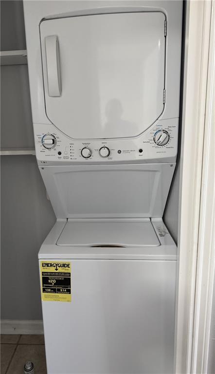 4518 Y A Tittle Ave Unit 6, Baton Rouge, LA 70820 - laundry area featuring stacked washer and clothes dryer, laundry area, and tile patterned flooring
