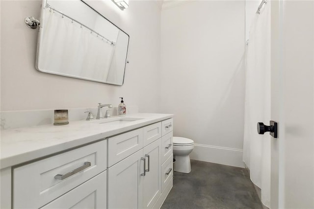 full bathroom featuring concrete flooring, toilet, vanity, and baseboards