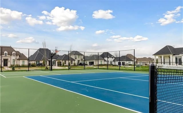 view of sport court featuring a residential view and fence