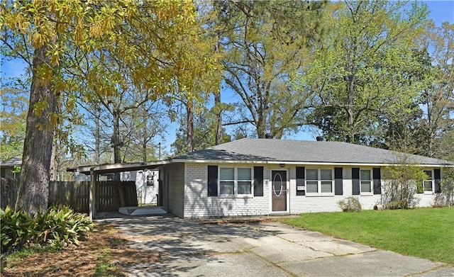 41158 2nd Colonial St, Prairieville, LA 70769 - ranch-style home with concrete driveway, fence, a front lawn, brick siding, and an attached carport