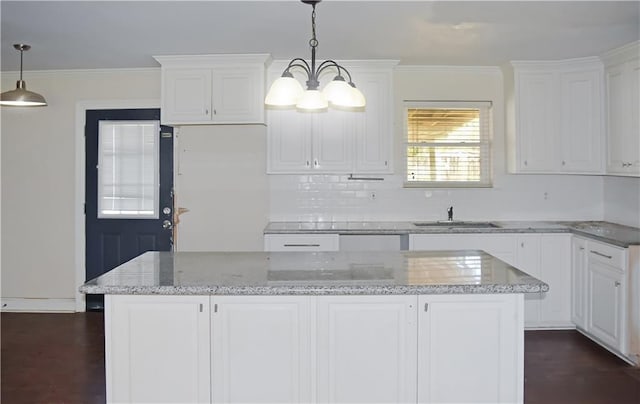 41158 2nd Colonial St, Prairieville, LA 70769 - kitchen with a sink, white cabinetry, dark wood finished floors, a center island, and ornamental molding