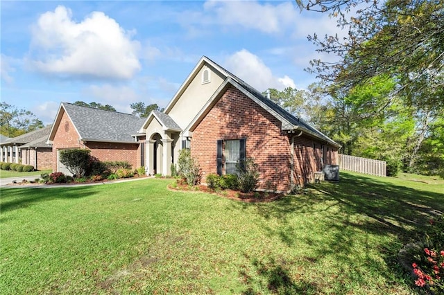 301 Clover Meadows Dr, Covington, LA 70433 - view of front of property featuring brick siding, a front yard, and stucco siding