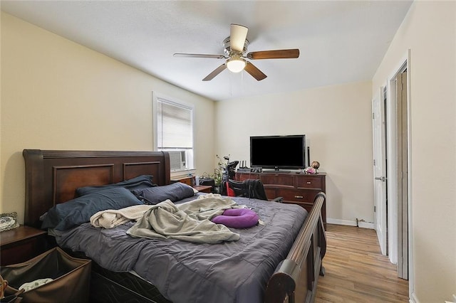 3212 Milan St, New Orleans, LA 70125 - bedroom featuring light wood-style floors, baseboards, cooling unit, and ceiling fan