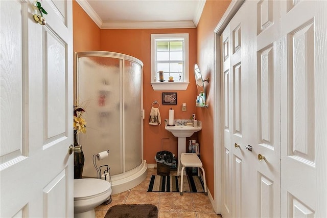 3212 Milan St, New Orleans, LA 70125 - bathroom with crown molding, a shower stall, toilet, tile patterned flooring, and baseboards