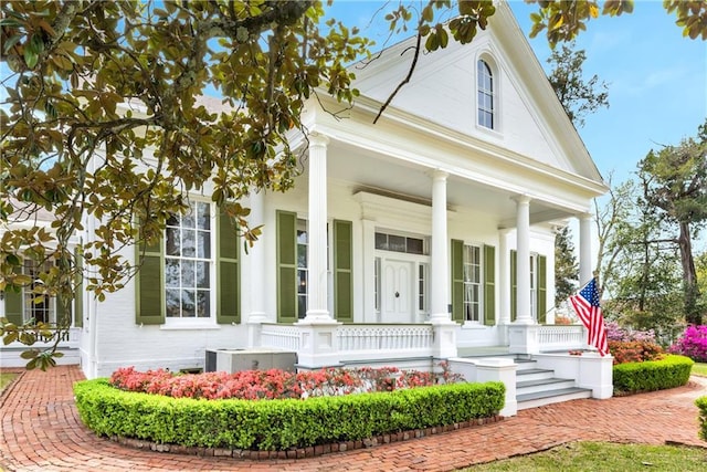 neoclassical / greek revival house with covered porch and central air condition unit