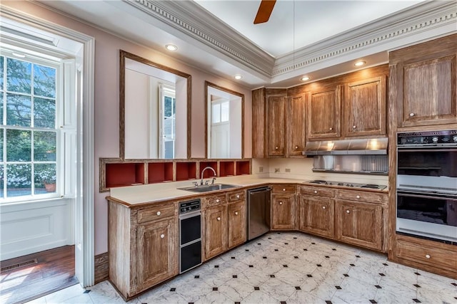 kitchen with a sink, cooktop, brown cabinetry, double oven, and dishwasher