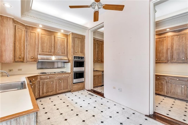 kitchen featuring a sink, double wall oven, ceiling fan, light countertops, and under cabinet range hood