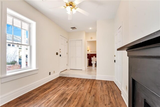 unfurnished living room featuring wood finished floors, baseboards, recessed lighting, and a ceiling fan