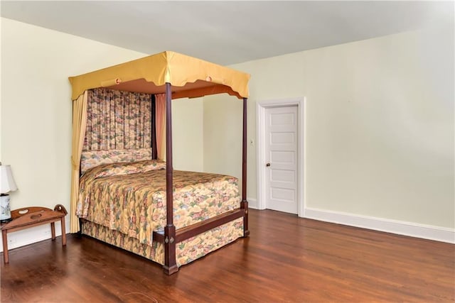bedroom featuring baseboards and wood finished floors