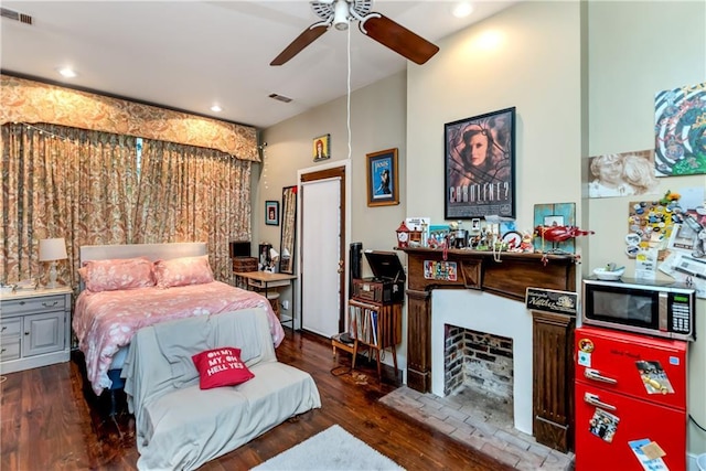 bedroom with recessed lighting, wood finished floors, and visible vents