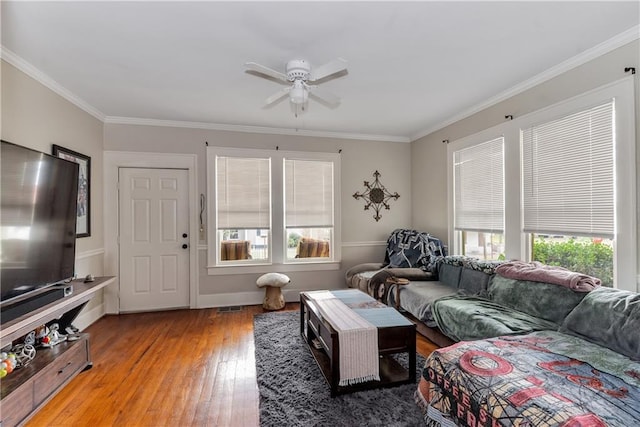 living room with ceiling fan, ornamental molding, hardwood / wood-style floors, and visible vents