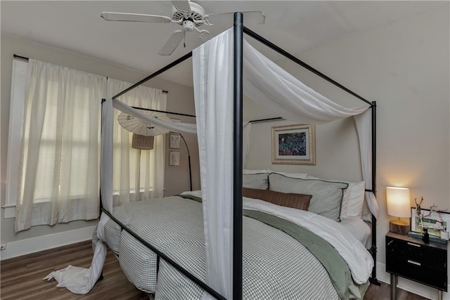 bedroom featuring ceiling fan, baseboards, and wood finished floors