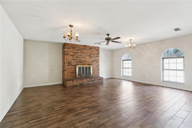 9180 Dancy Ave, Baton Rouge, LA 70814 - unfurnished living room with ceiling fan with notable chandelier, a fireplace, visible vents, and wood finished floors