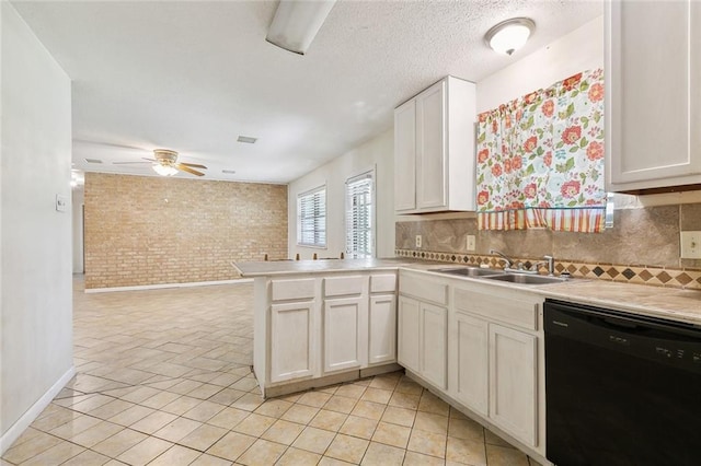 9180 Dancy Ave, Baton Rouge, LA 70814 - kitchen with a sink, backsplash, dishwasher, a peninsula, and brick wall