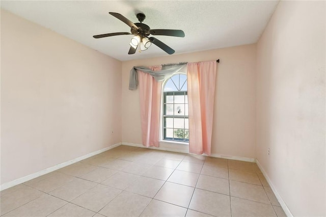 9180 Dancy Ave, Baton Rouge, LA 70814 - unfurnished room featuring baseboards, a textured ceiling, a ceiling fan, and light tile patterned floors