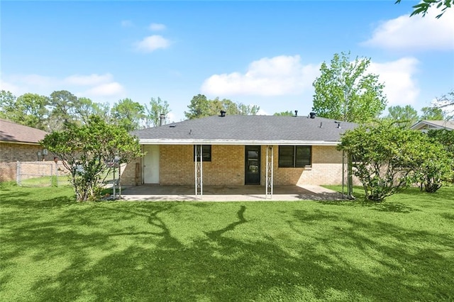 9180 Dancy Ave, Baton Rouge, LA 70814 - back of property with a lawn, a patio area, and brick siding
