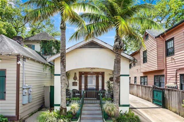 1830 Burgundy St, New Orleans, LA 70116 - view of front of property featuring covered porch and stucco siding