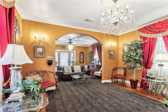 1830 Burgundy St, New Orleans, LA 70116 - living area featuring arched walkways, plenty of natural light, ornamental molding, a ceiling fan, and a chandelier