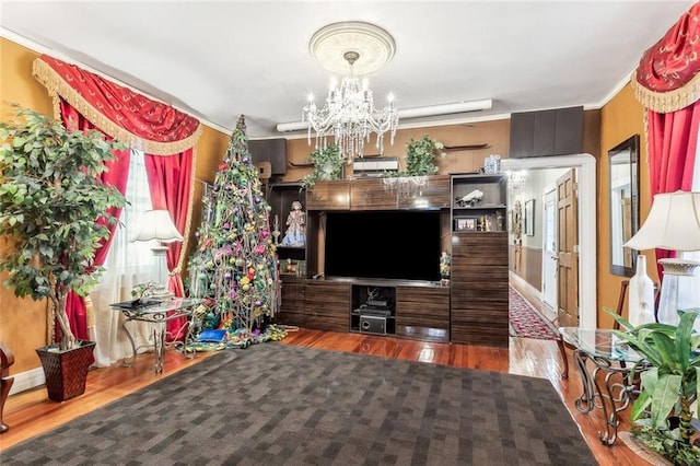 1830 Burgundy St, New Orleans, LA 70116 - living area featuring a chandelier, wood finished floors, and crown molding