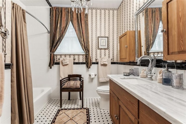 1830 Burgundy St, New Orleans, LA 70116 - bathroom with vanity, a chandelier, and shower / tub combo with curtain