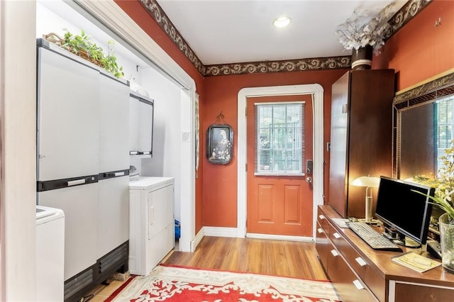 1830 Burgundy St, New Orleans, LA 70116 - foyer with washer / clothes dryer, light wood finished floors, and recessed lighting