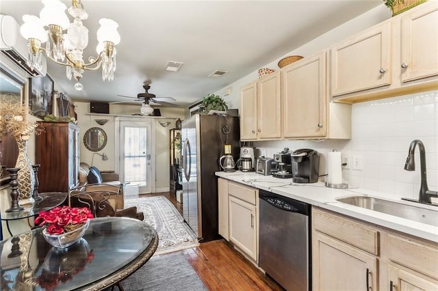 1830 Burgundy St, New Orleans, LA 70116 - kitchen with stainless steel appliances, a ceiling fan, dark wood-type flooring, light brown cabinetry, and backsplash