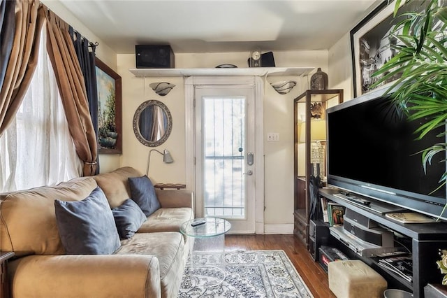 1830 Burgundy St, New Orleans, LA 70116 - living area with plenty of natural light and dark wood-style floors