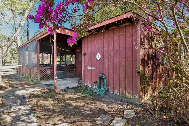 view of outdoor structure with a sunroom