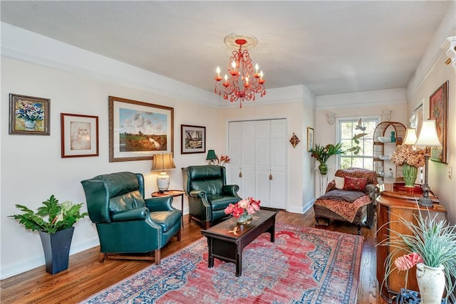living area featuring wood finished floors, baseboards, and an inviting chandelier