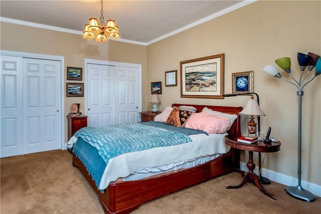 bedroom featuring two closets, ornamental molding, carpet floors, and a notable chandelier
