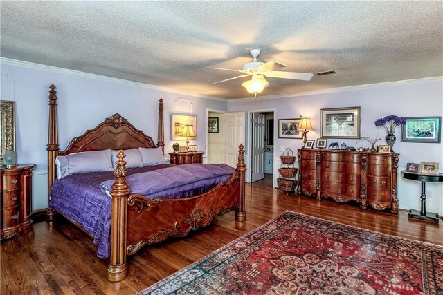 bedroom featuring wood finished floors, visible vents, a ceiling fan, crown molding, and a textured ceiling