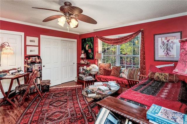 interior space featuring ornamental molding, wood finished floors, and a textured ceiling