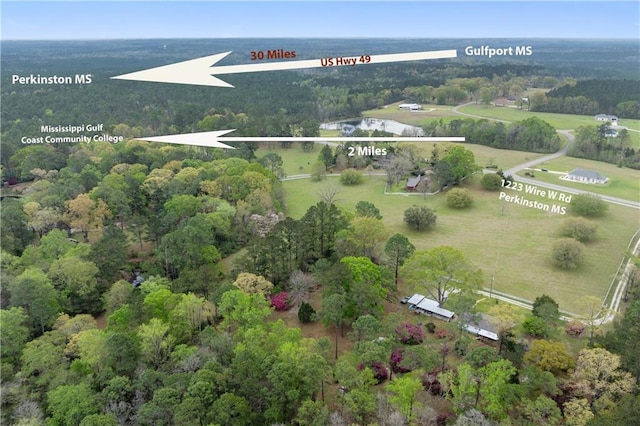 birds eye view of property with a forest view