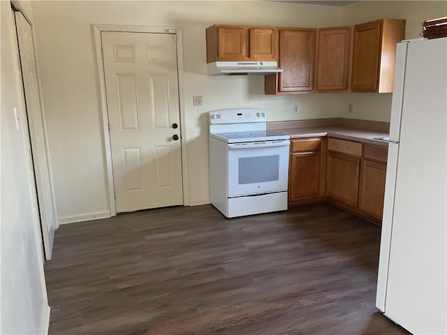 kitchen featuring white appliances, under cabinet range hood, dark wood-style flooring, light countertops, and baseboards