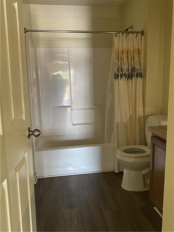 full bathroom featuring vanity, toilet, shower / bathtub combination with curtain, and wood finished floors