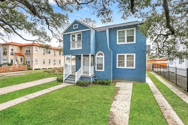 3415 Louisiana Ave Parkway, New Orleans, LA 70125 - view of front facade featuring a front yard, driveway, stucco siding, and fence
