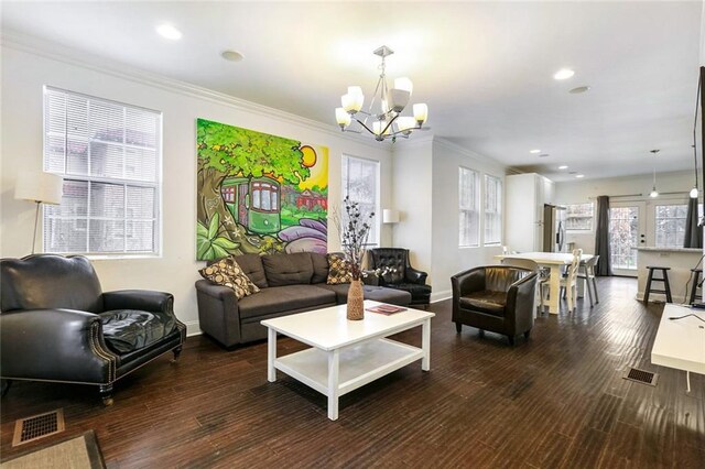 3415 Louisiana Ave Parkway, New Orleans, LA 70125 - living room featuring an inviting chandelier, ornamental molding, dark wood-type flooring, and visible vents