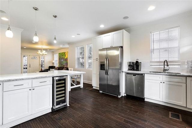 3415 Louisiana Ave Parkway, New Orleans, LA 70125 - kitchen featuring visible vents, appliances with stainless steel finishes, a sink, beverage cooler, and an inviting chandelier