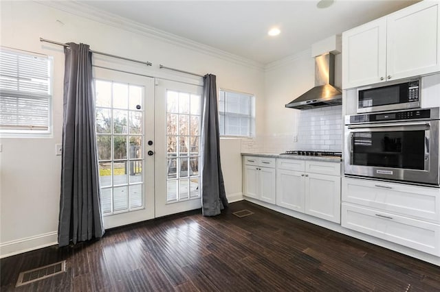 3415 Louisiana Ave Parkway, New Orleans, LA 70125 - kitchen with visible vents, ornamental molding, wall chimney exhaust hood, appliances with stainless steel finishes, and french doors